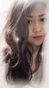 a close up of a woman 's face with long hair and red lips