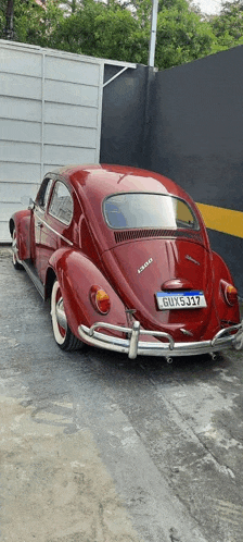 a red beetle with a license plate that says bux j17