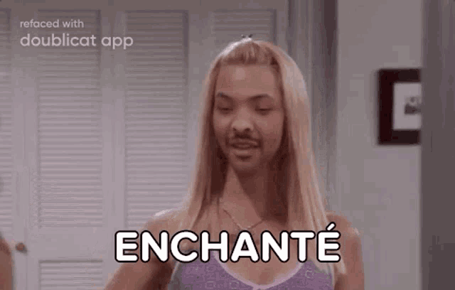 a woman with blonde hair and a beard is holding a glass of wine and says enchanté .
