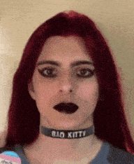 a woman wearing a choker that says bad kitty on it
