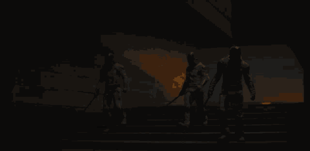 three men are walking down a set of stairs in the dark .