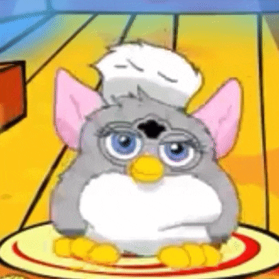 a cartoon furby is sitting on a plate with a chicken on its head .