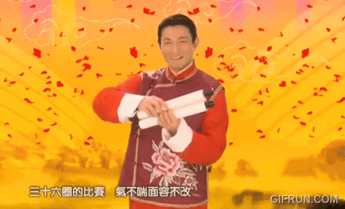 a man in a red vest is holding a sign with chinese characters on it