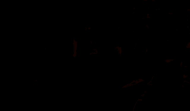 a person with their mouth open and their hands out in front of a window