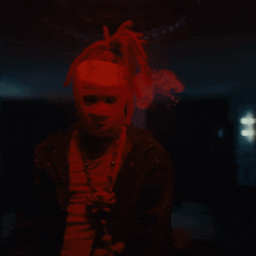 a man with dreadlocks and a red mask on his head