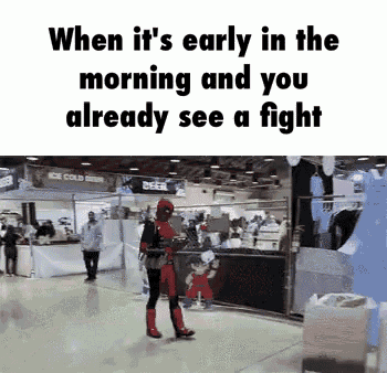a man in a spiderman costume is walking in a mall