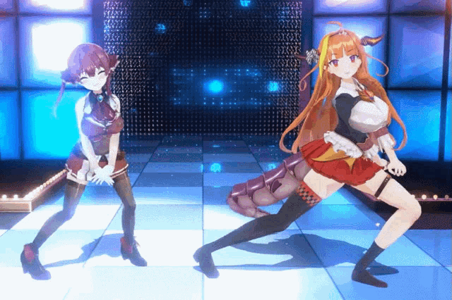two anime girls are dancing on a stage with a blue background