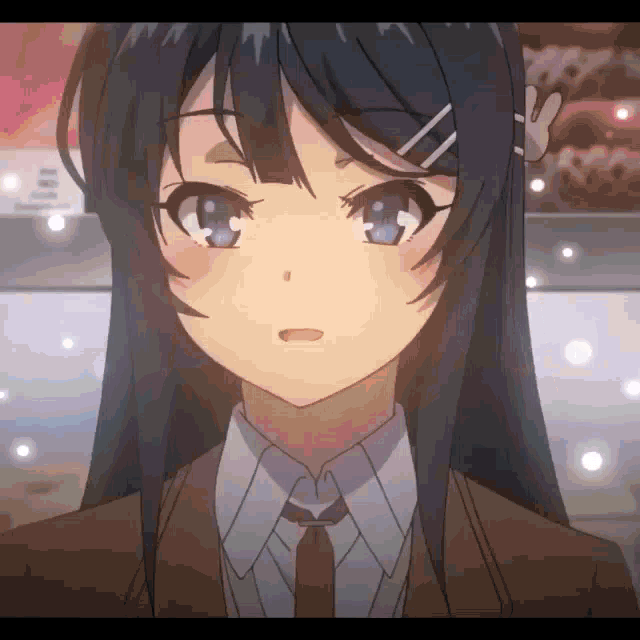 a close up of a girl 's face with long black hair and blue eyes