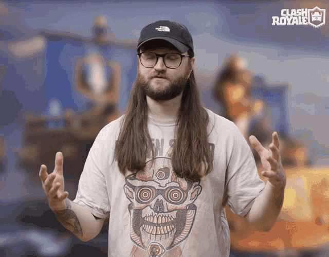 a man with long hair and glasses is wearing a shirt that says clash royale on it