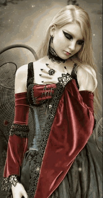 a woman in a gothic outfit with a red cape and gloves