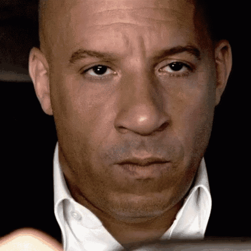 a close up of a man 's face with a white shirt