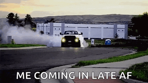 a truck is doing a burnout on a street with the words `` me coming in late af '' .