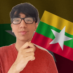 a man wearing glasses is holding a small flag with a white star