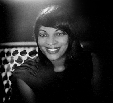 a black and white photo of a smiling woman with long hair