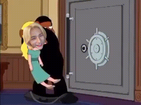 a man is holding a woman in his arms in front of a safe door .
