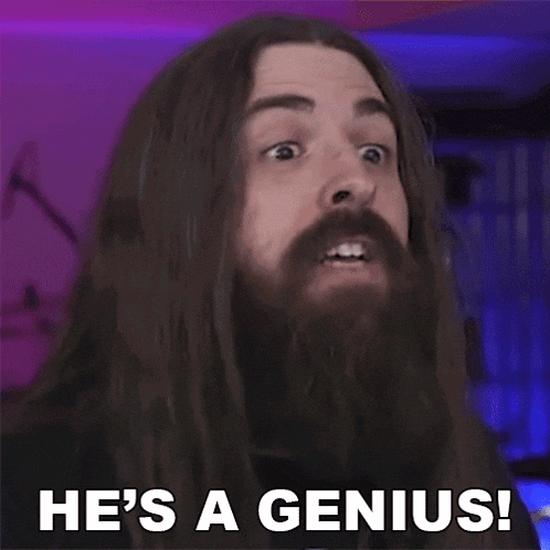 a man with long hair and a beard is saying `` he 's a genius ! ''