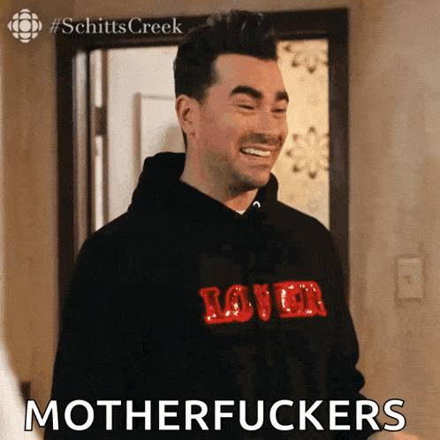a man wearing a hoodie that says lover on it