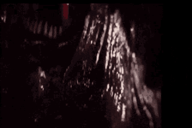 a close up of a monster 's mouth with sharp teeth coming out of it 's mouth .
