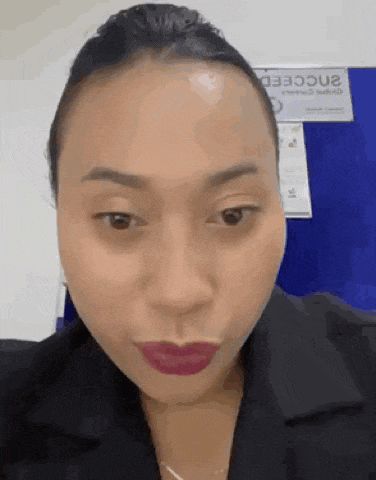 a close up of a woman 's face with red lipstick on her lips .