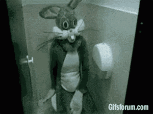 a person dressed as bugs bunny is sitting in a toilet .