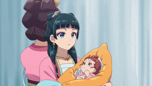 a woman is holding a baby in her arms while another woman looks on