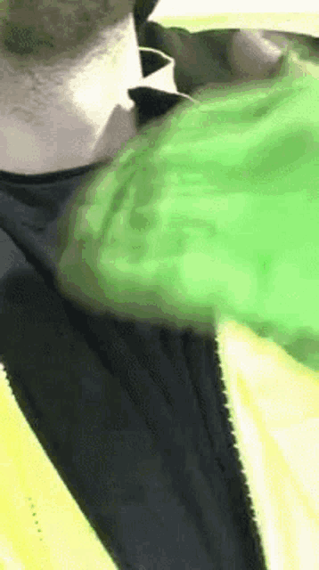 a man wearing a green jacket and a black shirt