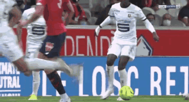 a soccer game is being played in front of a sign that says losc re1