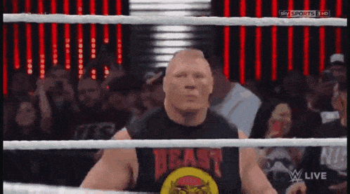 a man in a wrestling ring wearing a beast shirt