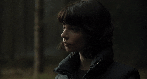a close up of a woman 's face with a dark background