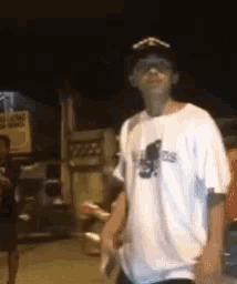 a man wearing a white t-shirt that says adidas