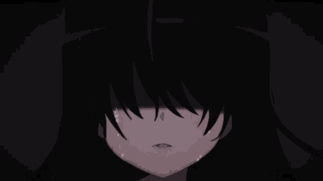 a girl with long black hair is crying in the dark