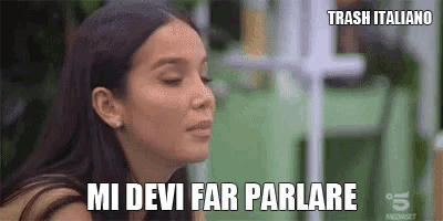 a woman is making a funny face with her eyes closed and the words `` mi devi far parlare '' .