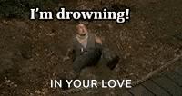 a man is drowning in a body of water with the words i 'm drowning in your love .