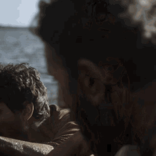 a man with a beard is looking at another man 's face