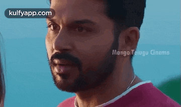 a man with a beard is looking at a woman .