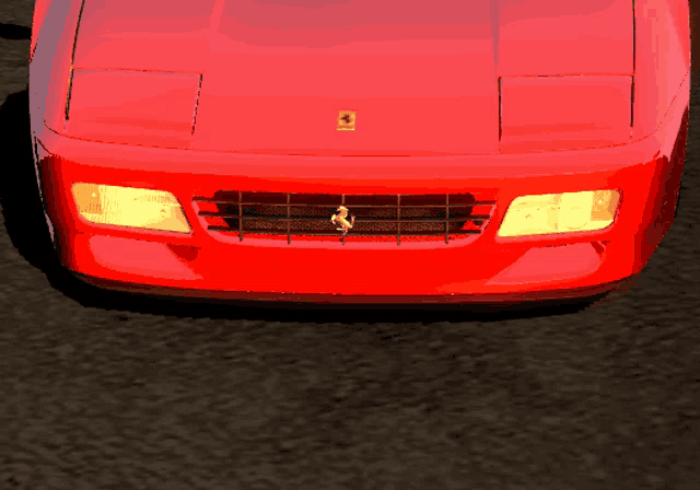 a red car with a ferrari emblem on the hood