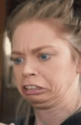 a close up of a woman making a funny face with her mouth open