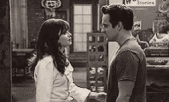 a black and white photo of a man and woman holding hands