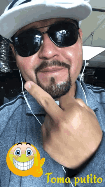 a man with a beard wearing sunglasses and a white hat is giving a thumbs up sign