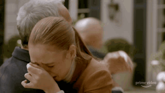 a woman is crying while being hugged by a man and the words prime video are visible in the corner
