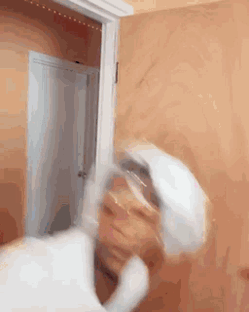 a person in a white hat is standing in a doorway .