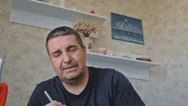a man is holding a lit candle in his hand