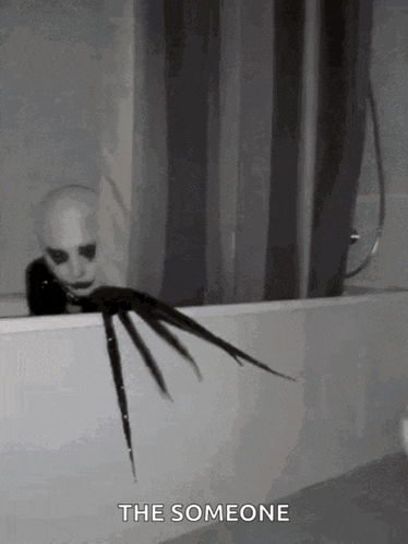 a black and white photo of a scary clown in a bathtub with a caption that says the someone .