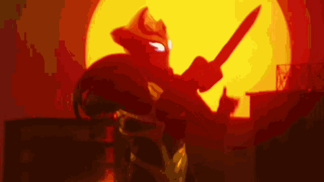a silhouette of a person holding a knife in front of a red sun .