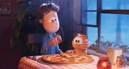 a boy and a stuffed animal are sitting at a table with a pizza on it