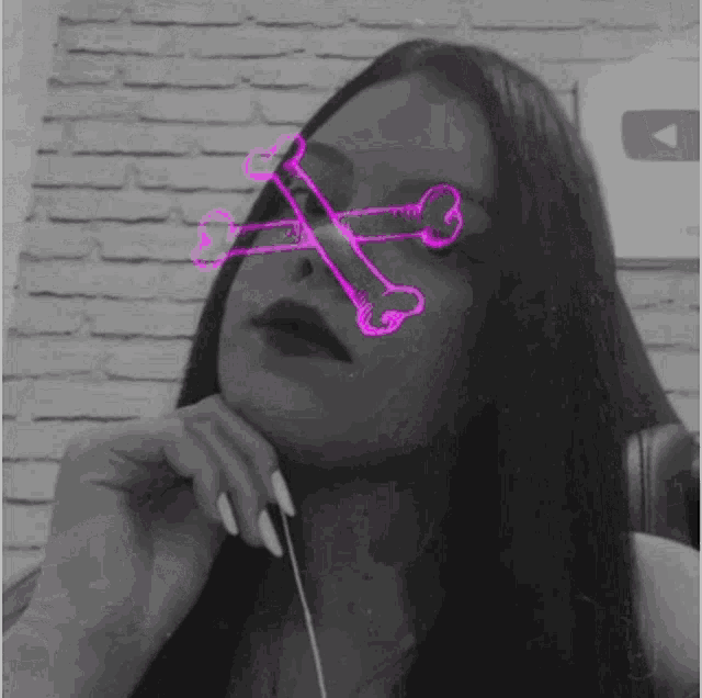 a black and white photo of a woman with neon bones on her eyes .