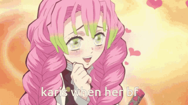 a girl with pink hair and green eyes is smiling while holding her hand to her face .