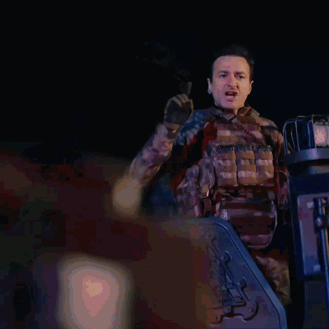 a man in a military uniform is screaming with his mouth wide open