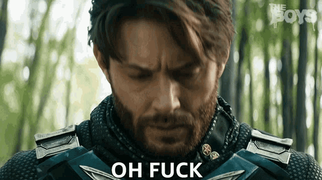 a man with a beard is wearing a superhero suit and says oh fuck