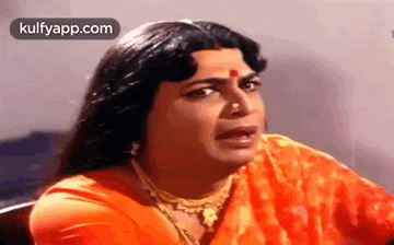 a man dressed as a woman is making a funny face in a movie .